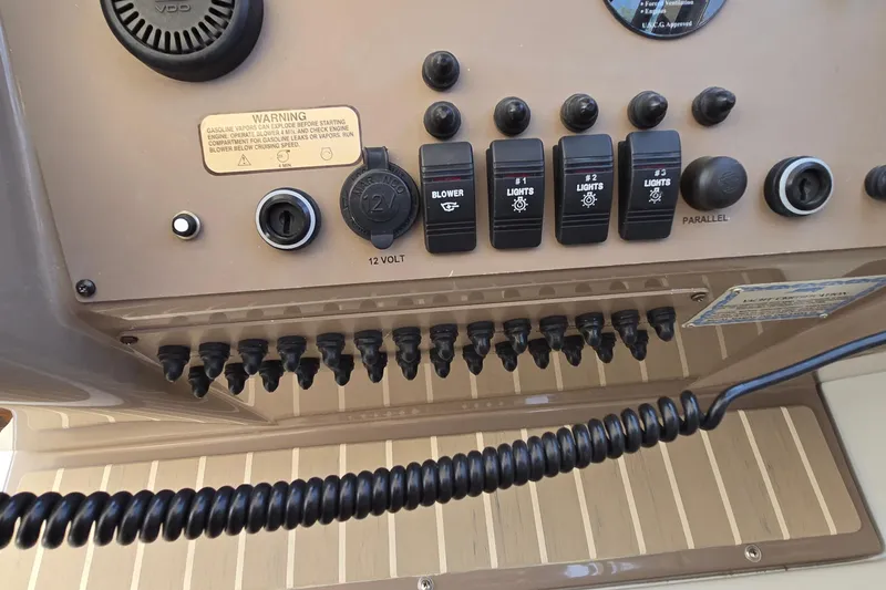 Slide: The Image of Control panel of a 2003 Regal Commodore 4260 boat with switches and warning label. - 15