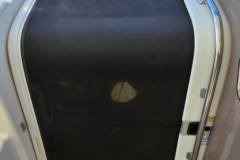 Slide: The Image of 2003 Regal Commodore 4260 boat door with black screen and metal frame. - 17