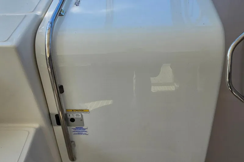 Slide: The Image of 2003 Regal Commodore 4260 boat interior with stainless steel handrail and caution label. - 18