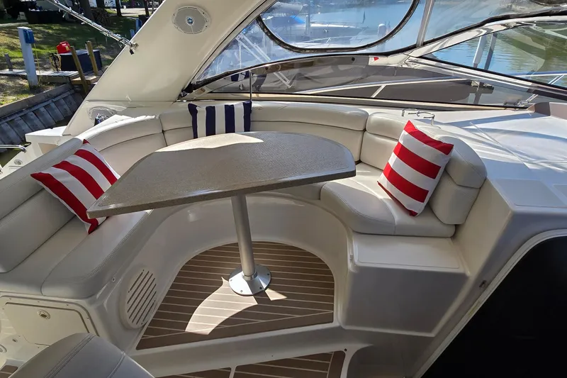 Slide: The Image of Luxurious seating area on 2003 Regal Commodore 4260 yacht with striped cushions and table. - 19