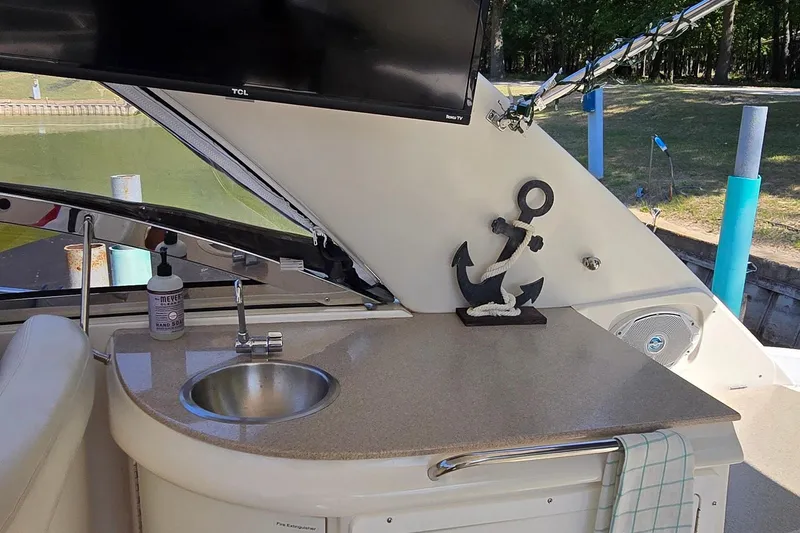 Slide: The Image of 2003 Regal Commodore 4260 yacht interior with sink, anchor decor, and TV. - 23