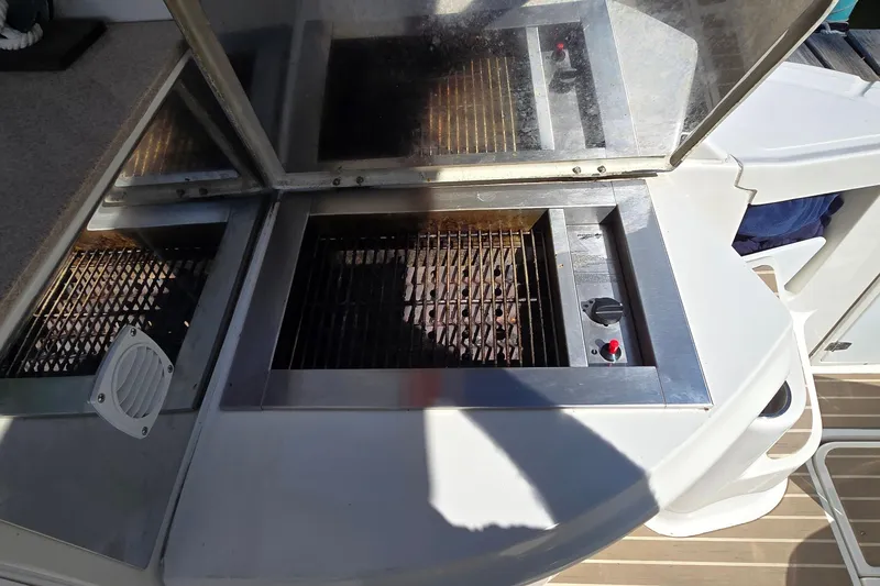 Slide: The Image of Outdoor grill on 2003 Regal Commodore 4260 yacht, featuring stainless steel design. - 25