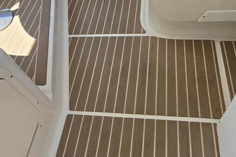 Slide: The Image of Teak-patterned deck flooring on a 2003 Regal Commodore 4260 boat. - 32