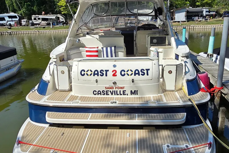 Slide: The Image of 2003 Regal Commodore 4260 boat docked, featuring "Coast 2 Coast" signage, Caseville, MI. - 4