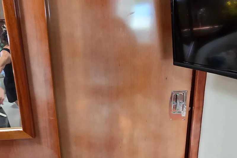 Slide: The Image of Interior of 2003 Regal Commodore 4260 yacht with wooden paneling and mounted TV. - 40