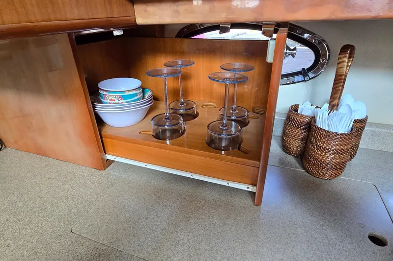 Slide: The Image of Kitchen storage in 2003 Regal Commodore 4260 yacht with dishes and glasses. - 47