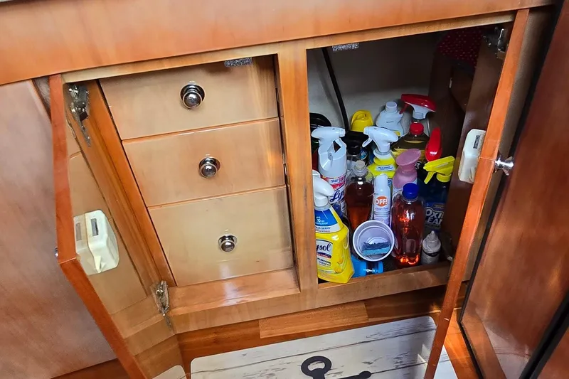 Slide: The Image of Cabinet in 2003 Regal Commodore 4260 yacht with cleaning supplies and drawers. - 52