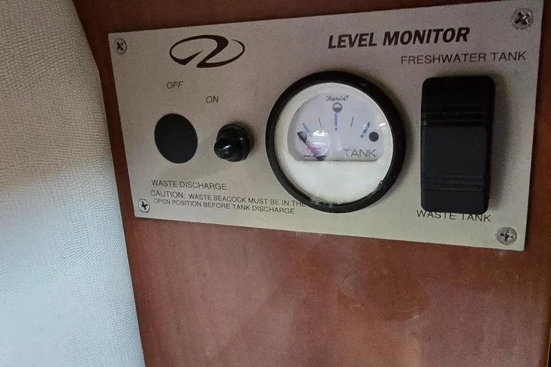 Slide: The Image of Level monitor panel on 2003 Regal Commodore 4260 boat, showing freshwater and waste tank gauges. - 53