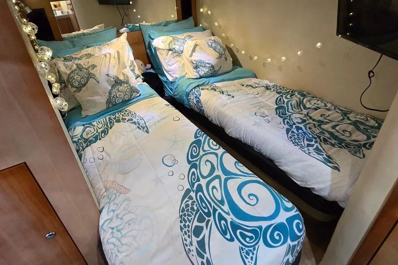 Slide: The Image of Twin beds with turtle-themed bedding in a 2003 Regal Commodore 4260 cabin. - 57