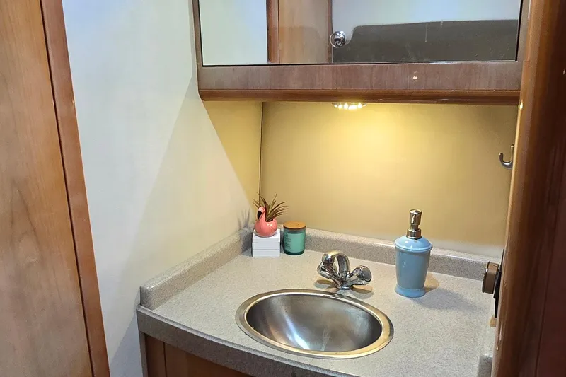 Slide: The Image of Compact bathroom sink area in 2003 Regal Commodore 4260 yacht. - 59