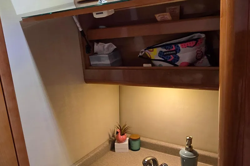 Slide: The Image of 2003 Regal Commodore 4260 bathroom with wooden cabinet, sink, and decorative items. - 60