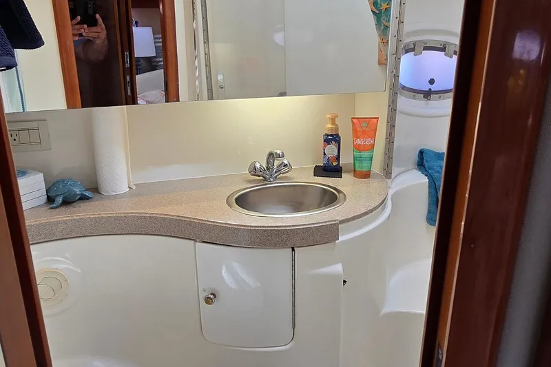 Slide: The Image of Bathroom interior of 2003 Regal Commodore 4260 yacht with sink and toiletries. - 63