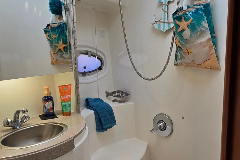 Slide: The Image of Bathroom interior of 2003 Regal Commodore 4260 yacht with nautical decor. - 64