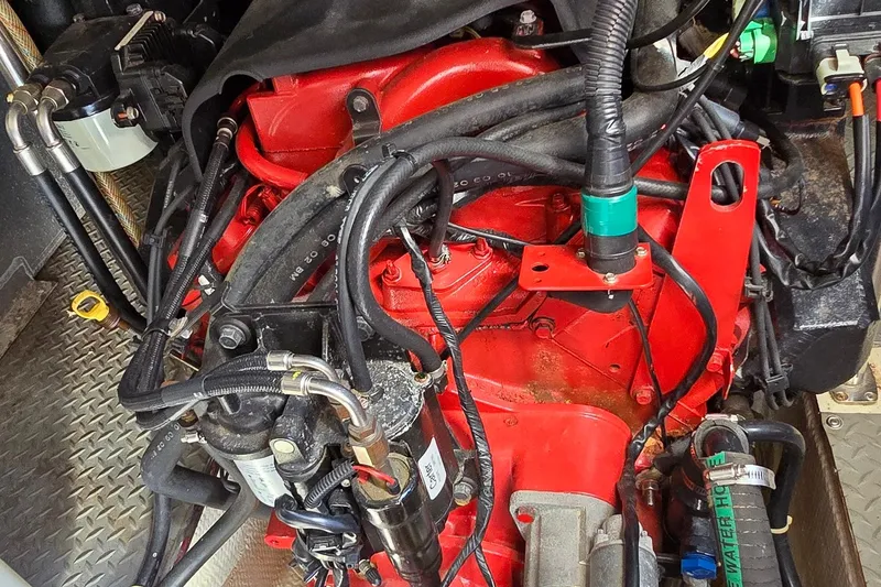 Slide: The Image of Engine compartment of a 2003 Regal Commodore 4260 boat, featuring red engine components. - 68