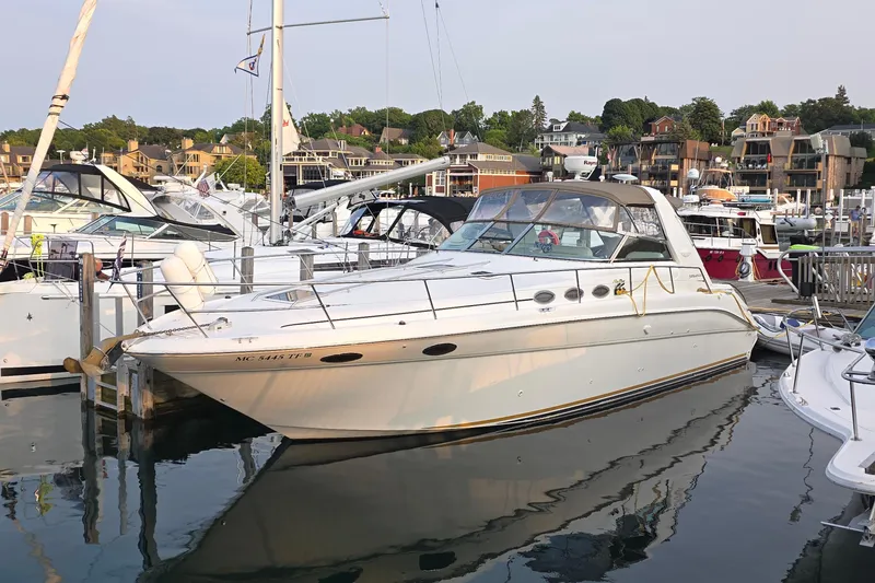 The Image of 1998 Sea Ray 370 Sundancer yacht docked in a marina, surrounded by other boats. - 0