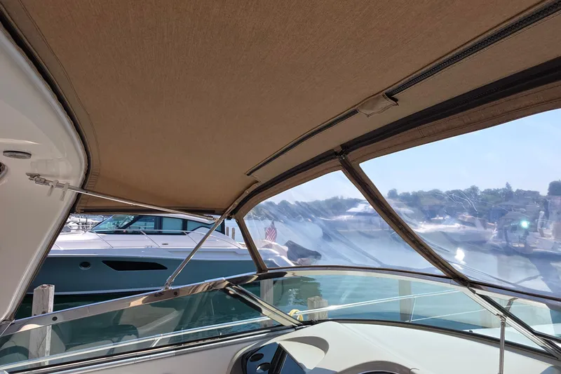 Slide: The Image of Interior view of 1998 Sea Ray 370 Sundancer boat with canopy and clear windows. - 16