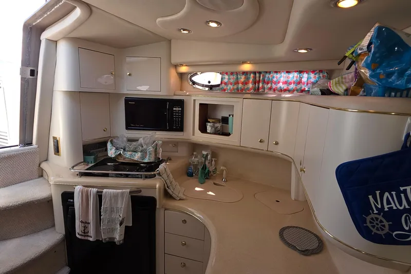 Slide: The Image of Interior of a 1998 Sea Ray 370 Sundancer yacht kitchen with modern amenities. - 17