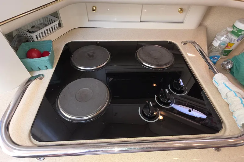 Slide: The Image of Modern kitchen stove on 1998 Sea Ray 370 Sundancer yacht, featuring sleek design and controls. - 20