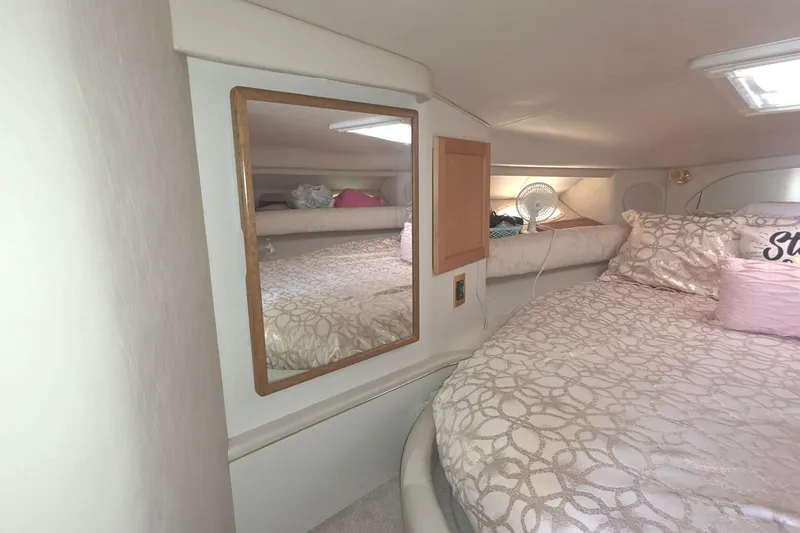 Slide: The Image of Cozy cabin interior of 1998 Sea Ray 370 Sundancer with bed and mirror. - 21