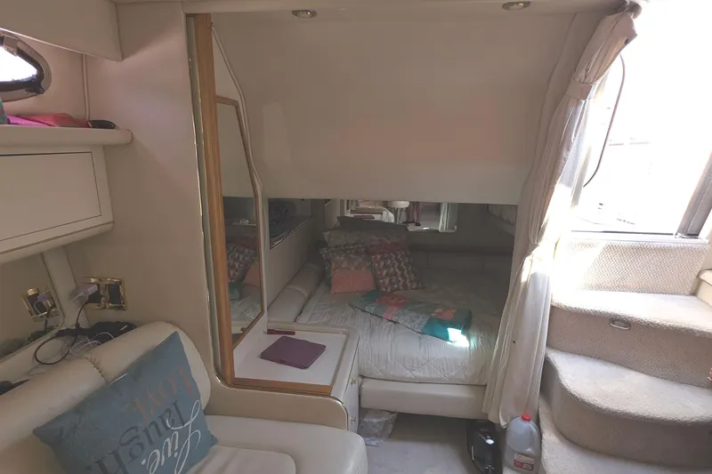 Slide: The Image of Interior of 1998 Sea Ray 370 Sundancer yacht with cozy cabin and seating area. - 22