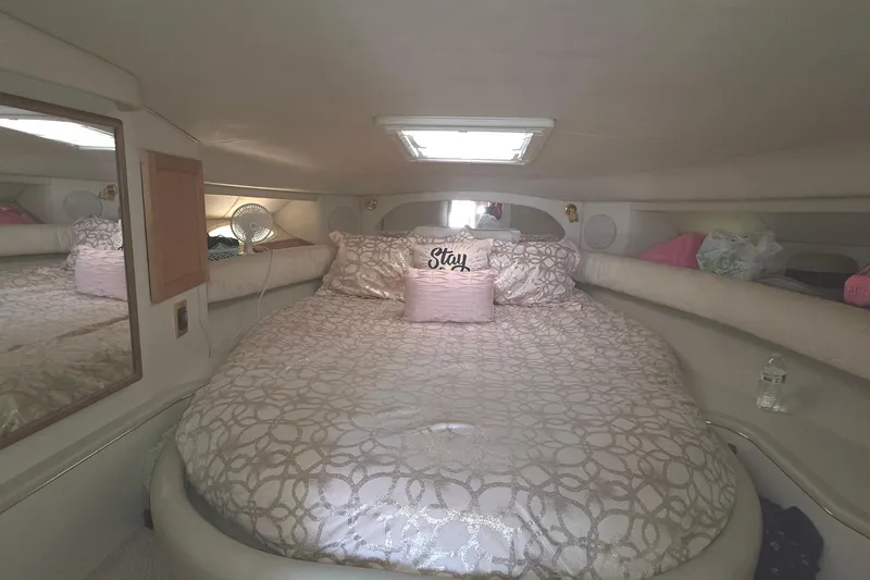 Slide: The Image of Cozy cabin interior of 1998 Sea Ray 370 Sundancer with plush bedding and decorative pillows. - 24