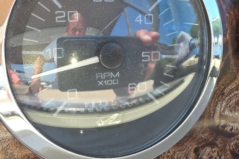 Slide: The Image of Close-up of a 1998 Sea Ray 370 Sundancer RPM gauge reflecting surroundings. - 30