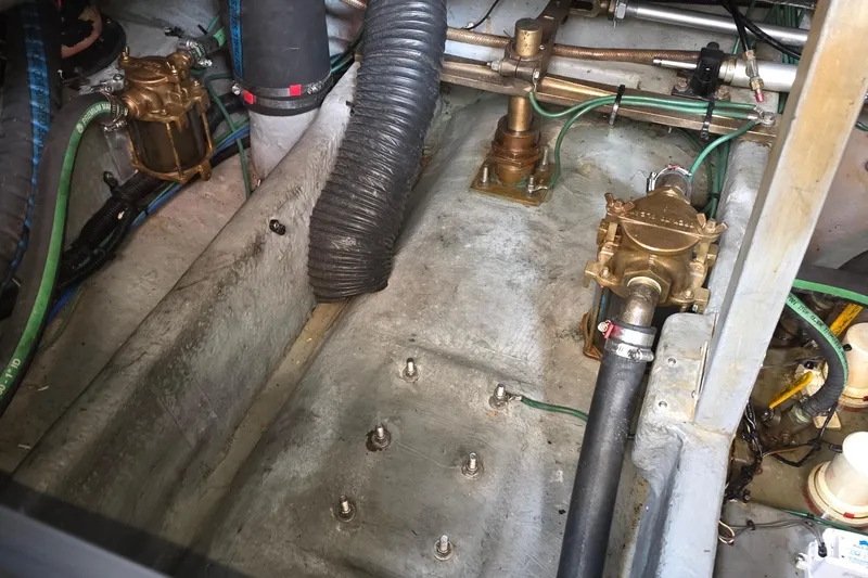 Slide: The Image of Engine compartment of a 1998 Sea Ray 370 Sundancer, showing mechanical components and hoses. - 35