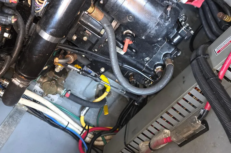 Slide: The Image of Engine compartment of a 1998 Sea Ray 370 Sundancer with visible wiring and components. - 37