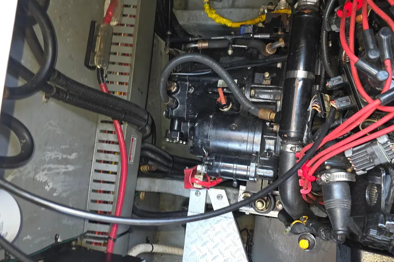 Slide: The Image of Engine compartment of a 1998 Sea Ray 370 Sundancer with visible wiring and components. - 38