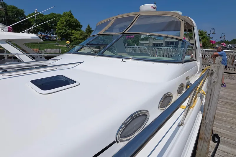 Slide: The Image of 1998 Sea Ray 370 Sundancer docked, showcasing sleek design and modern features. - 5