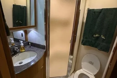 Slide: The Image of Interior of 2001 Bayliner 5288 Pilot House Motoryacht with modern kitchen and marina view. - 10