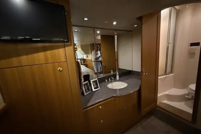 Slide: The Image of 2001 Bayliner 5288 Pilot House Motoryacht kitchen with white cabinetry and appliances. - 12