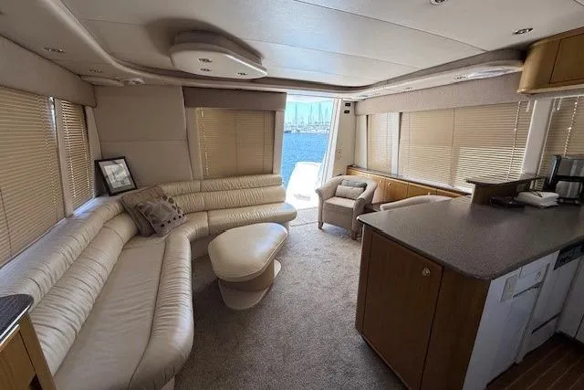 Slide: The Image of 2001 Bayliner 5288 Pilot House Motoryacht docked in a marina under clear blue skies. - 2