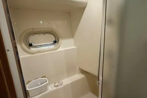 Slide: The Image of 2001 Bayliner 5288 Pilot House Motoryacht bathroom with porthole and shower. - 28