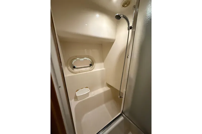 Slide: The Image of Shower area in 2001 Bayliner 5288 Pilot House Motoryacht with porthole and handheld showerhead. - 29