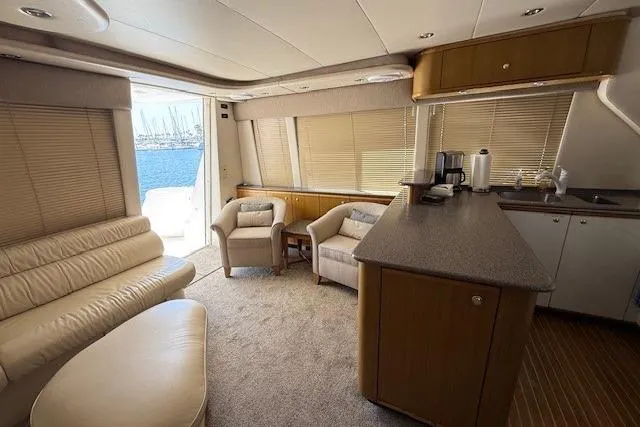 Slide: The Image of 2001 Bayliner 5288 Pilot House Motoryacht cruising in a marina under clear blue skies. - 3