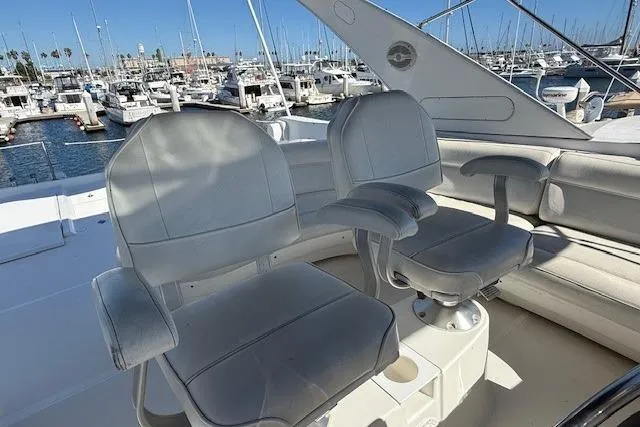 Slide: The Image of 2001 Bayliner 5288 Pilot House Motoryacht helm seats with marina view. - 35
