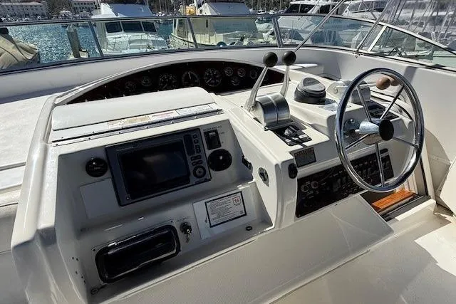 Slide: The Image of 2001 Bayliner 5288 Pilot House Motoryacht helm with steering wheel and navigation controls. - 36
