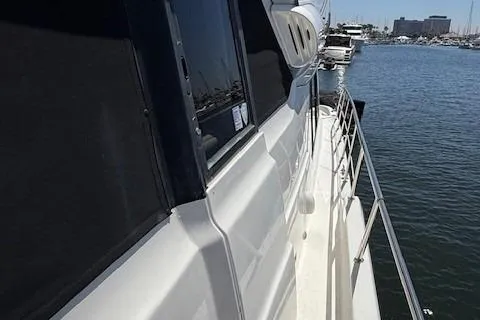 Slide: The Image of 2001 Bayliner 5288 Pilot House Motoryacht docked in a marina, side view. - 43