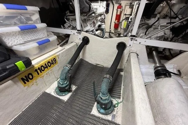 Slide: The Image of Engine room of 2001 Bayliner 5288 Pilot House Motoryacht with hoses and storage boxes. - 46