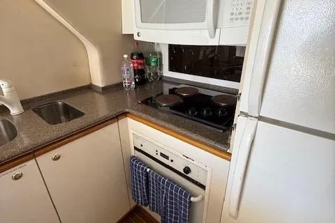 Slide: The Image of 2001 Bayliner 5288 Pilot House Motoryacht docked in a marina, clear blue sky. - 5