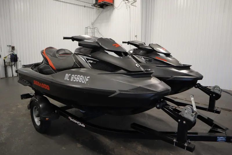 Slide: The Image of 2013 Sea-Doo GTX 260 iS Limited jet skis on trailer in garage. - 3