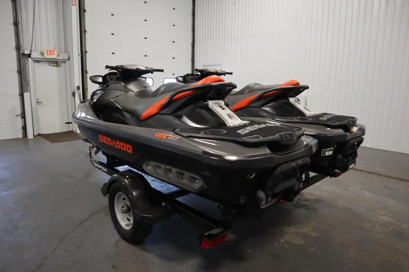 Slide: The Image of 2013 Sea-Doo GTX 260 iS Limited jet skis on trailer in garage setting. - 7