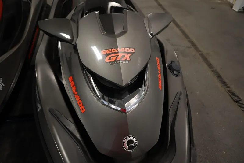 Slide: The Image of 2013 Sea-Doo GTX 260 iS Limited jet ski, gray with red branding, parked indoors. - 9