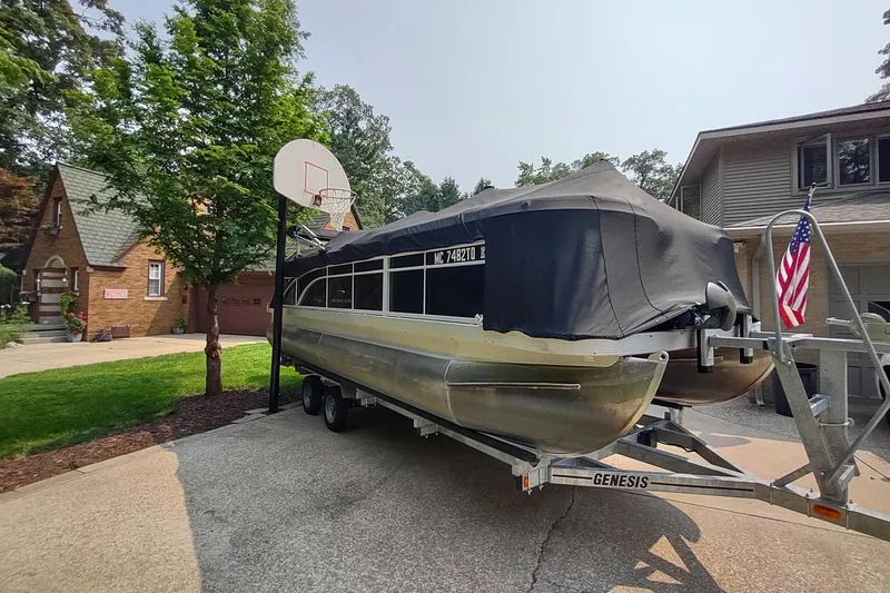 Slide: The Image of 2013 Bennington 22 SSX pontoon boat on trailer in residential driveway. - 10