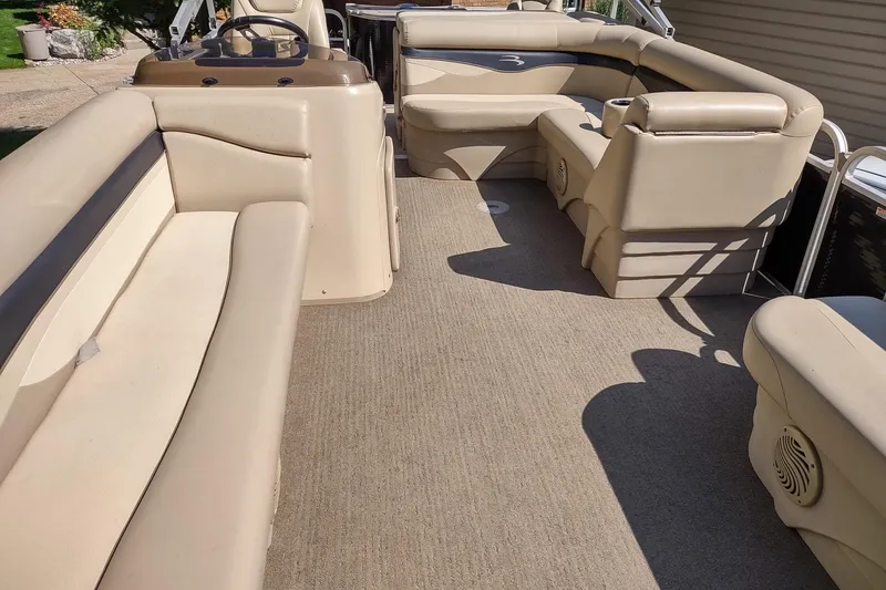 Slide: The Image of 2013 Bennington 22 SSX pontoon boat interior with beige seating and carpeted floor. - 6