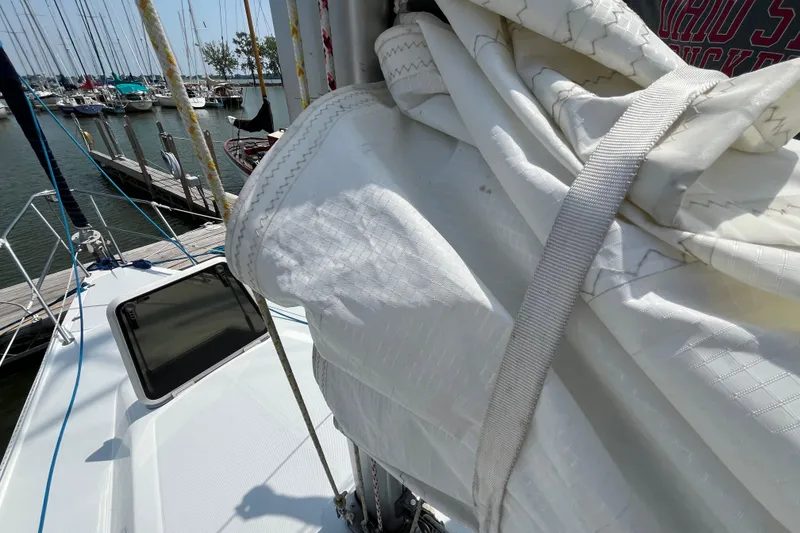 Slide: The Image of Catalina 320 sailboat from 2000 with sails furled, docked at marina. - 11