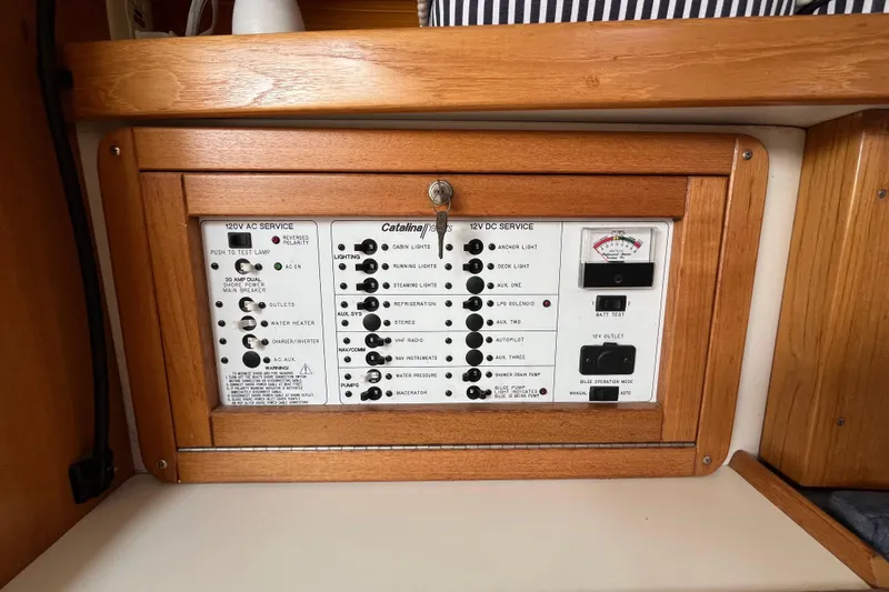 Slide: The Image of Electrical panel of a 2000 Catalina 320 sailboat, featuring AC and DC service controls. - 18