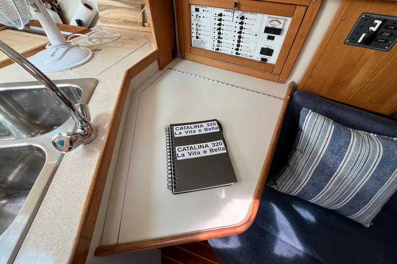 Slide: The Image of Interior of a 2000 Catalina 320 sailboat with a notebook and control panel. - 19