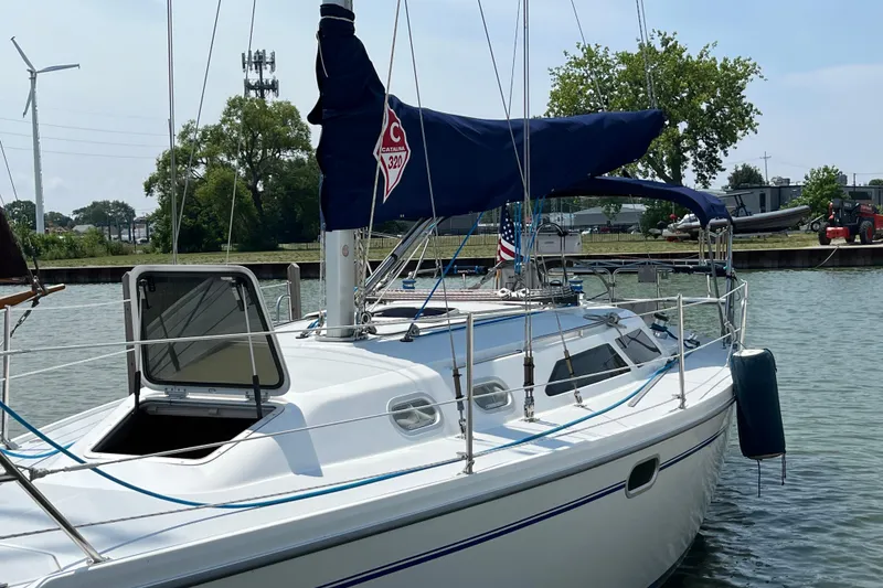 Slide: The Image of Catalina 320 sailboat from 2000 docked in a marina with open hatch. - 2